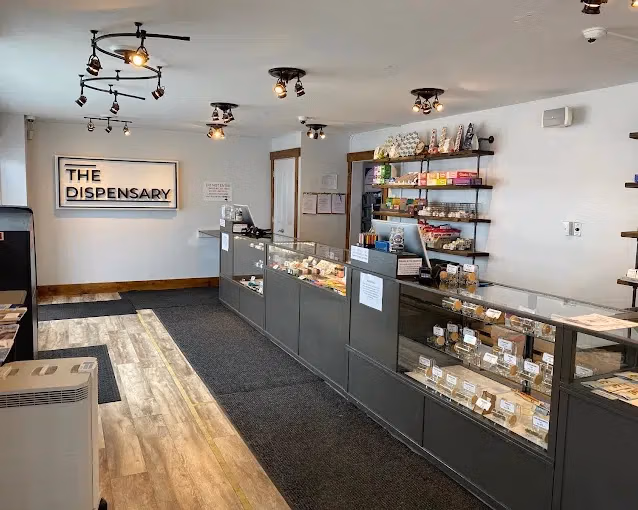 The interior of The Dispensary in Breckenridge shows a clean store with black counters displaying product behind glass